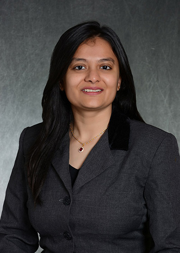A headshot of Janki Hiteshkumar Gosai in front of a grey background.